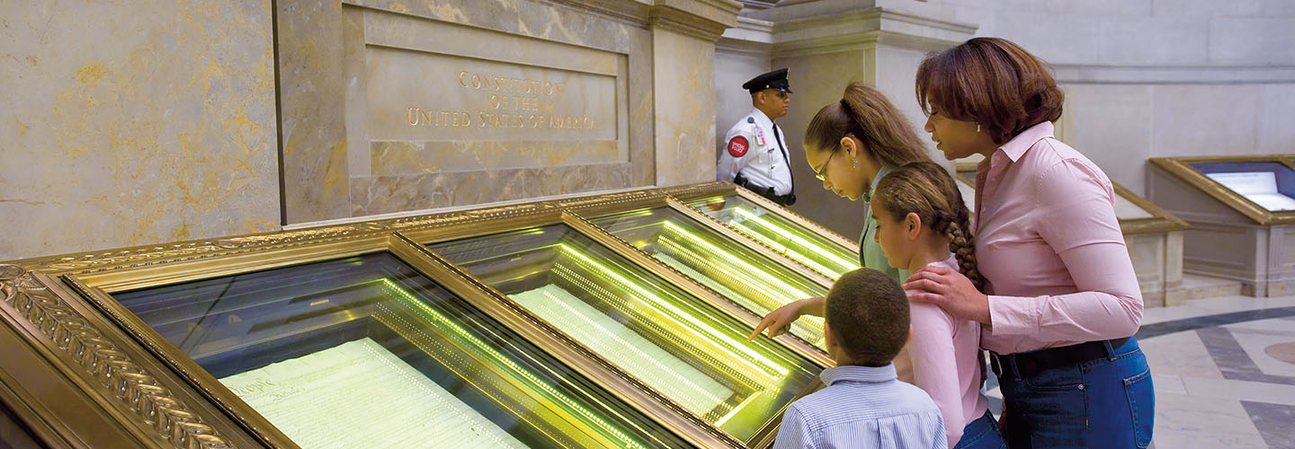 Image of people in a museum looking at historical documents
