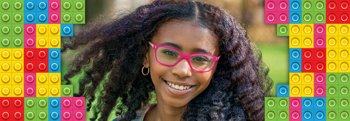 A girl with long curly unbraided hair and pink glasses