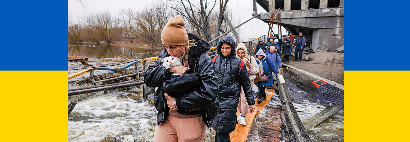 Photo of a people walking away from a destroyed building